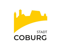 Gelbes Logo der Stadt Coburg mit stilisierter Silhouette und Schriftzug "Stadt Coburg" darunter